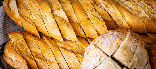 Fresh fragrant breads on the table. Bakery food concept panorama or wide banner photo background