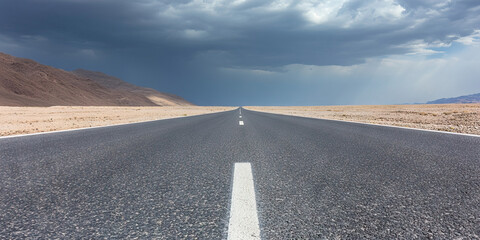 Asphalt Road in Desert Landscape Under Cloudy Sky