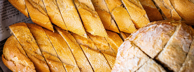 Fresh fragrant breads on the table. Bakery food concept panorama or wide banner photo background