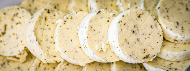 Festa cheese slices, feta garlic, herbs and spices background. Side view, selective focus...
