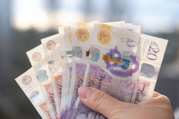 Close-up female hands counting uk pounds bills, paper money on blurred background, British GBP banknotes, Money Management Accuracy, salary, payments to fund, financial freedom, save up for vacation