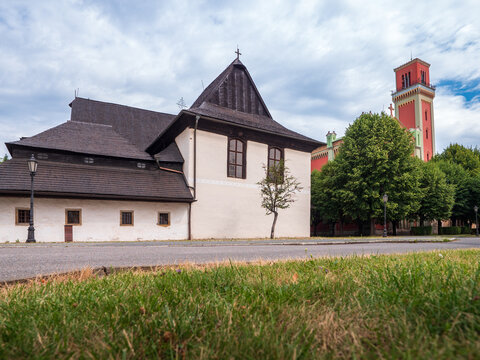 Two Evangelical churches in Kežmarok, Slovakia &mdash; a historic wooden articular church and a large modern brick church side by side.
