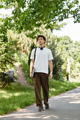 Young man enjoying a relaxing day in the sun at a lush summer park