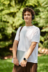 Young man enjoying leisure time in a vibrant summer park with nature around him