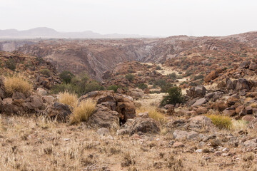 The rugged and desolate landscape of the Augrabies National Park, South Africa, with only part of the Orange River Gorge visible in the background