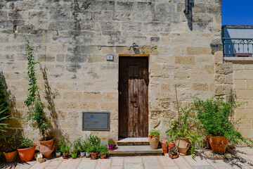 The facade of an old house in Acaya, a medieval town in the province of Lecce, Italy.