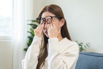 Eye care problem concept, fatigue asian young woman tired eyes irritated rubbing, massage eye dry...