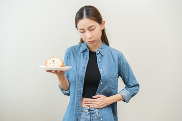 Gluten allergy, asian young woman hand holding, refusing to eat white loaf slice on plate in...