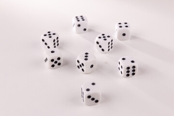 A random arrangement of dice and a puzzle cup, captured after the dice have been cast.