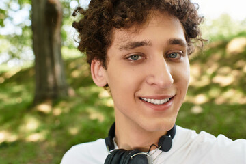 Enjoying the warmth of summer days, a young man relaxes in the park