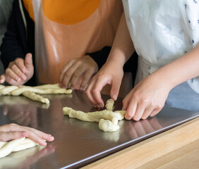 Children learn to make pastries from raw dough. Culinary master class on making buns