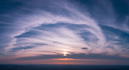 sunset in the sky wiyh white and black clouds
