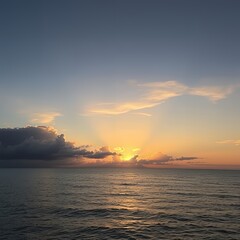 Naklejka premium Serene ocean sunset with golden hues and dramatic clouds