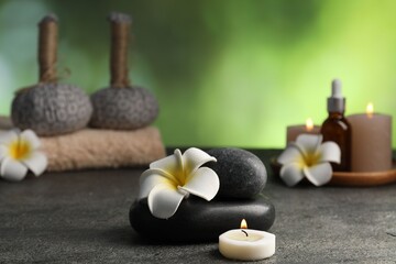 Composition with spa stones on grey table, closeup