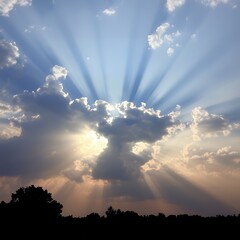 Dramatic sun rays breaking through stormy clouds at sunset