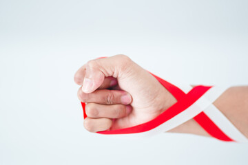 Red And White Ribbon On Hand