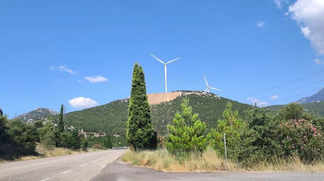 Video of the National Road 48 (EO48), a scenic single carriageway connecting Livadeia and Amfissa in central Greece, winding through mountains, forests, and near historic Delphi and modern wind farms.