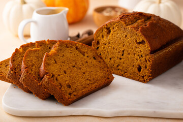 Pumpkin bread freshly baked and sliced on a serving board