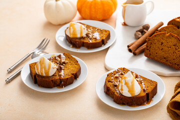 Pumpkin bread freshly baked and sliced on a serving board