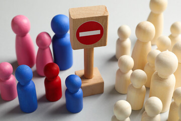 Unemployment. Many different human figures and stop sign on light background, closeup