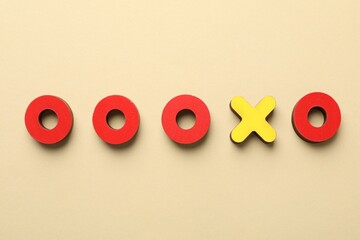 Unemployment. Tic tac toe figures on beige background, flat lay