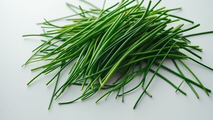 Fototapeta premium Fresh green garlic chives on a white surface.
