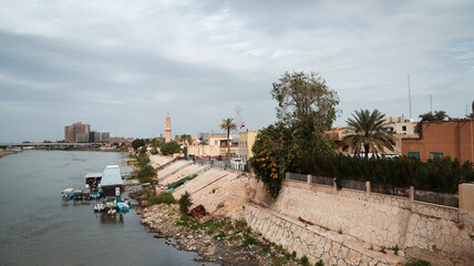 Waterfront view of Baghdad with unique architecture and boats along the Tigris River