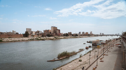 View of the Tigris River and Baghdad skyline during daylight hours