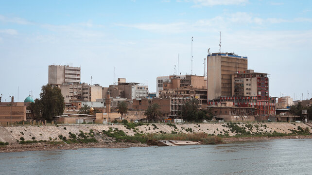Baghdad city view along the river showcasing urban life and architecture