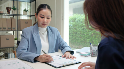 Asian female audit ESG risk check list paper form net zero waste supply chain vendor eco go green carbon credit control. Asia people woman give advice report prepare work review best practice process.