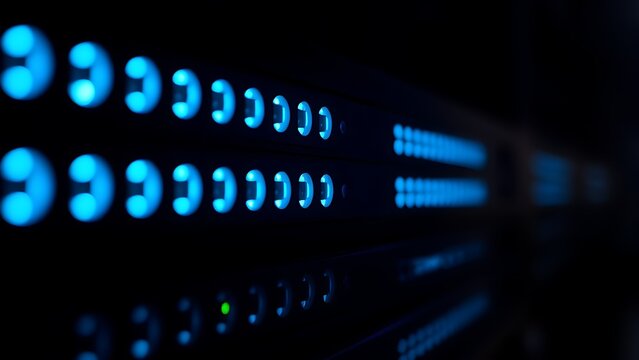 Close-up of glowing blue server rack lights creating an abstract technological pattern on a dark background.