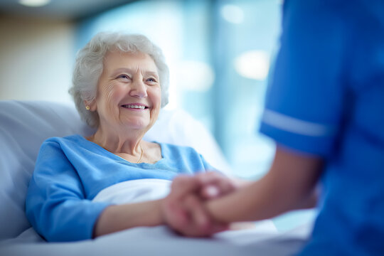 Senior woman smiling gently while holding hands with compassionate nurse. Soft lighting enhances warm atmosphere in modern hospital. Concept of healthcare, elderly care, wellness