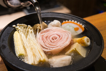 Group enjoy hot pot dinner at restaurant table