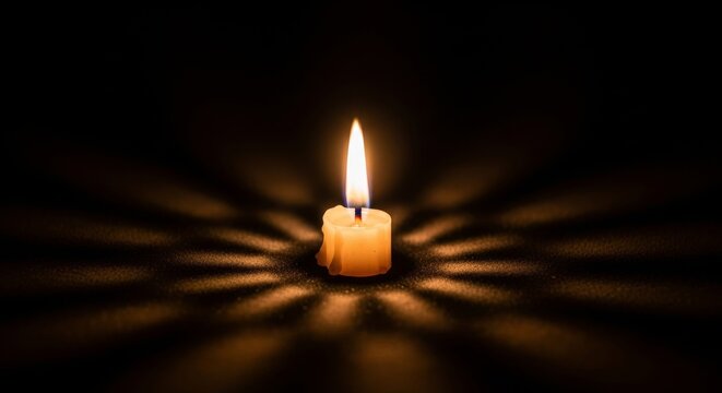 Candles radiant flame in shadowy darkness