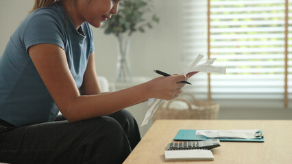 Cost of living income expense saving budget in black asia people Gen Z young adult woman. Looking...