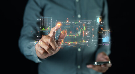 A person interacts with a digital interface displaying financial charts and data, symbolizing technology-driven stock market analysis.