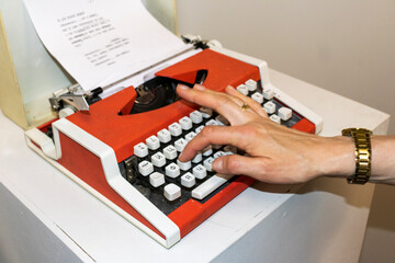 Woman typing on the old, vintage, russian typewriter