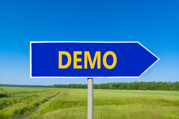 Demo symbol. Concept word Demo on beautiful blue road sign. Beautiful blue sky green grass and forest peaceful nature background. Business and demo concept. Copy space.