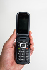Hand holding a retro vintage cellular flip phone