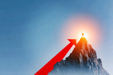 Hiker standing on mountain peak with red arrow pointing upward symbolizing success growth achievement goal progress concept. Copy space