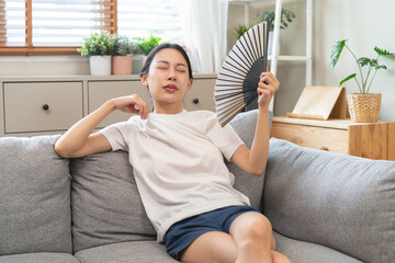 Suffering summer heat wave stroke, hot weather, tired asian young woman feeling discomfort sweaty,...