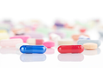 A red and a blue pill represent a difficult choice or dilemma. A concept for decision, reality, and...