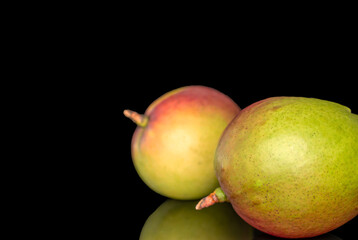 Fototapeta premium Juicy fresh mango isolated on black background, close-up.