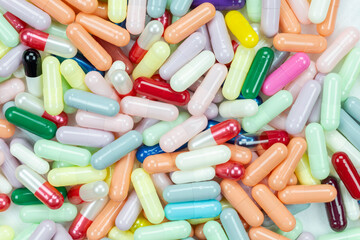 op view of a vibrant medicine background with many colorful capsule pills. A versatile...