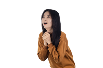 Young Asian woman looking up with a hopeful expression. A portrait of gratitude, faith, and wishing, with hands clasped in prayer or relief isolated on white background with clipping path.