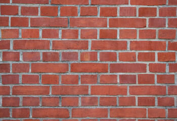 Red brick wall with white mortar joints