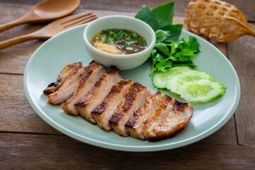 Grilled pork neck and thai spicy dipping sauce on plate
