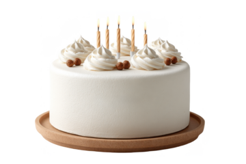 A round white frosted cake topped with six lit candles, decorated with swirls of cream and small brown nuts or berries.