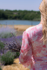 Woman by the Lake Holding Lavender Bunch, Back View
