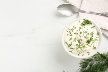 Delicious yogurt in bowl, dill and spoon on white marble table, flat lay. Space for text